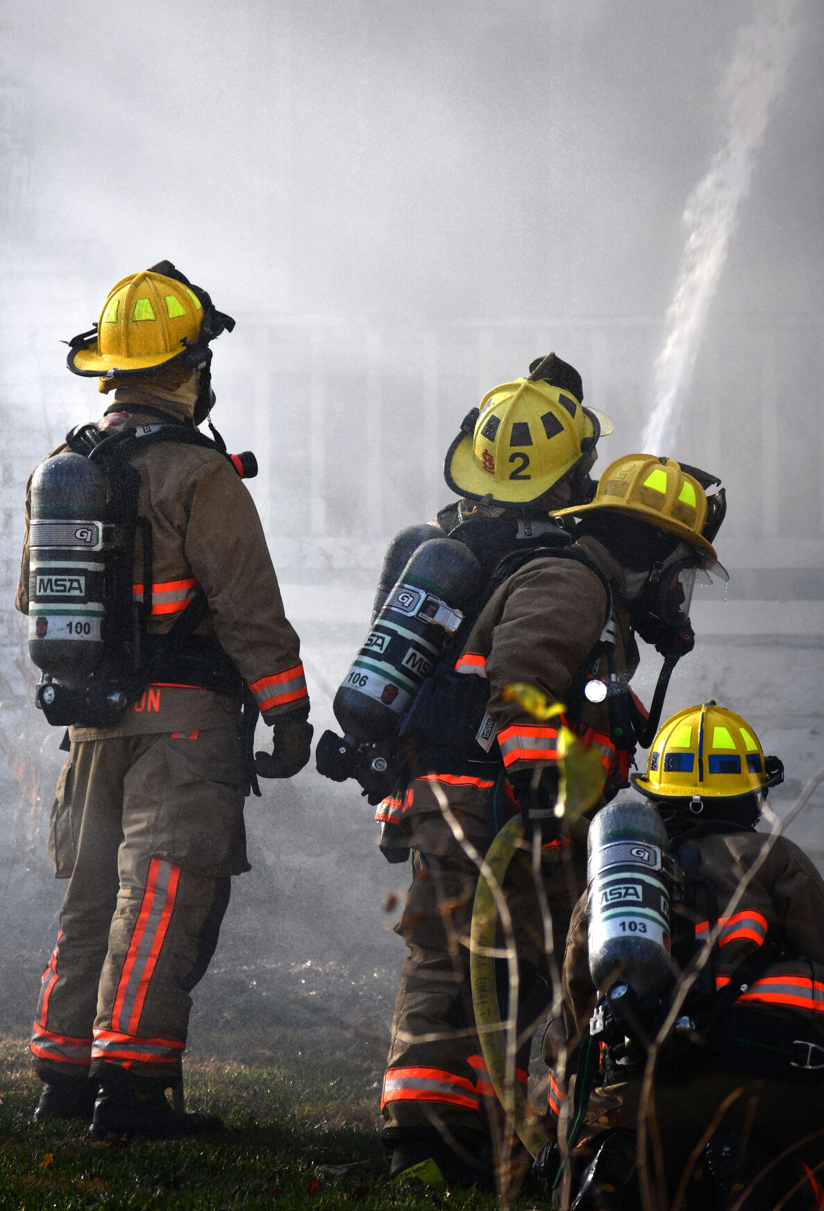 Firefighters use a hose